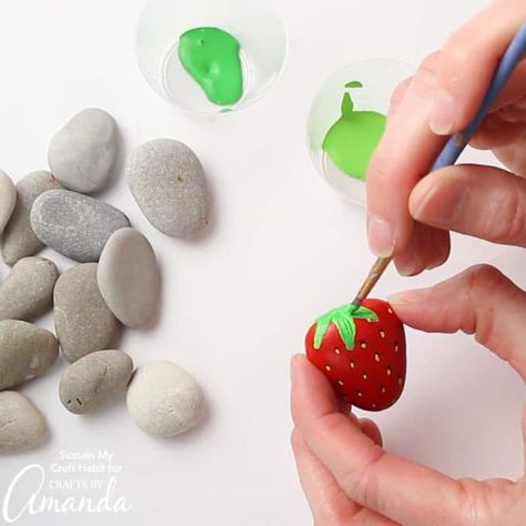 These strawberries look good enough to eat! Turn some pretty pebbles into sweet strawberry painted rocks following these simple step by step instructions. #strawberry #adultcrafts #kidscrafts #paintedrocks #rockpainting #gardencrafts #garden #summercrafts #gardendecor #outdoordecor Strawberry Rocks, Garden Rock Art, Outdoor Crafts, Pom Pom Crafts, Beautiful Peacock, Painted Rocks Diy, Rock Painting Ideas Easy, Painting Rocks, Different Shades Of Green