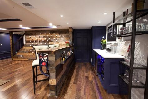 Even pint-sized basements can pull off a dramatic color in small doses. This open-floorplan basement demonstrates how thoughtful color placement can pack panache into the design without visually shrinking the space. A saturated-indigo color coats the built-in bar cabinets, the walls and doors as well as highlighting the vertical surfaces in the tray ceiling. The rest of the ceiling and the bar are a snowy-white hue that balance out the deep indigo tones and the room's rich wood finishes. Paint y Basement Paint Color Ideas, Best Color Combos, Basement Color Schemes, Built In Bar Cabinet, Basement Wall Colors, Exposed Basement Ceiling, Basement Craft Rooms, Basement Paint, Family Room Paint Colors