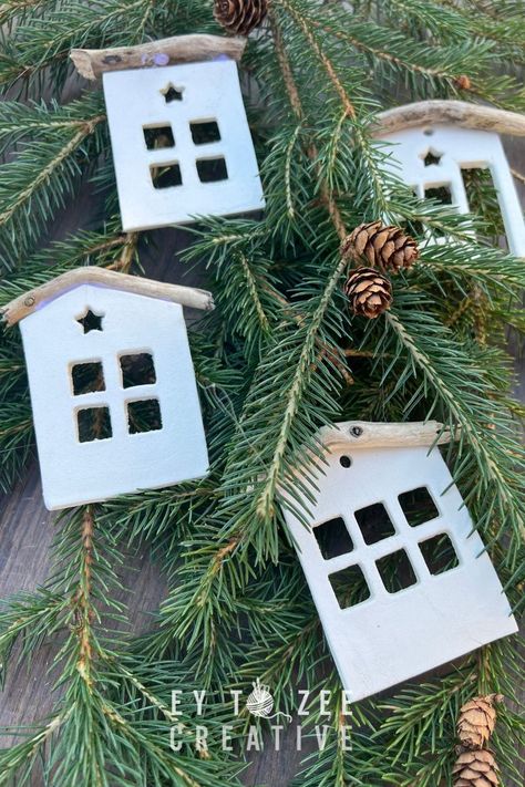 These cute tiny house air-dry clay ornaments make up a Christmas village on your tree. And for a few bucks in materials, you can make beautiful decorations. Clay House Ornaments Diy, House Clay Ornament, Air Dry Clay Houses How To Make, Dry Clay Christmas Ornaments, Modelling Clay Christmas Decorations, Air Dry Christmas Decorations, Air Dry Clay Xmas Decorations, January Diy Crafts, Air Dry Clay Houses Diy