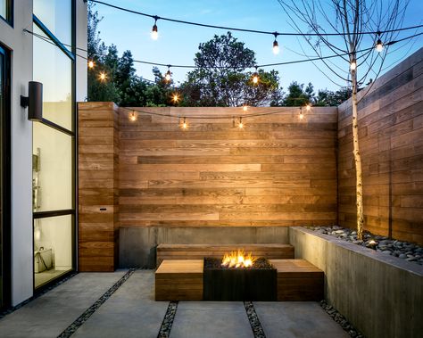 Back patio with wood siding, concrete walls and flooring and a fire pit Simple Deck Ideas, Modern Landscape Lighting, Garden Lighting Ideas, Small Patio Ideas, Simple Deck, Raised Patio, Concrete Patios, Patio Lights, Patio Pergola