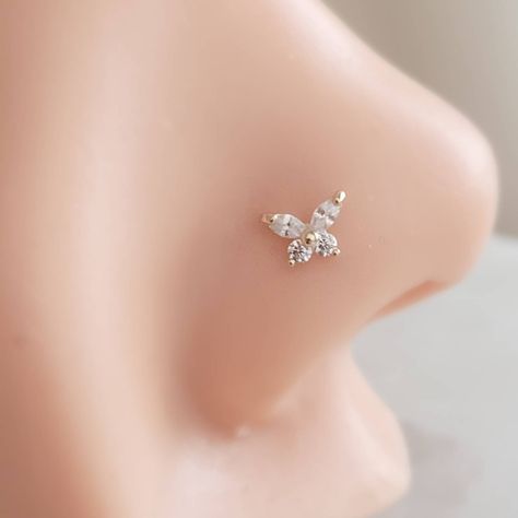 "⚡️ FREE SHIPPING ⚡️ on Domestic orders over $35 🇺🇸 🦋 Dainty and feminine, our 14k gold & Diamond CZ Butterfly nose stud is sure to be a favorite! * T H E * D E T A I L S *  * Solid 14K Gold with Cubic Zirconia accents * Choose from 14k Yellow or White Gold * Butterfly measures 5mm x 4.2mm * Post is 20 gauge * Thoughtfully packaged & ready for gift giving! * Handmade, just for you, in our sunny California Studio * Our 365 Guarantee: Our jewelry is guaranteed for 1 year after purchase date against defects. * Your body jewelry is sent in a gloss white jewelry box & our signature \"Studio Blue\" satin drawstring pouch, (shown in the last photo). * RETURN * POLICY * DETAILS * Items that cannot be returned:  * EARRINGS * BODY JEWELRY * SALE ITEMS  * CUSTOM ITEMS (including but not limited to Fun Nose Studs, Butterfly Nose Stud, Cute Nose Rings Studs, Nose Piercing Jewelry Studs, Nose Piercing Stud Diamond, Feminine Nose, Butterfly Nose Piercing, Nose Stud Jewelry, Stud Aesthetic