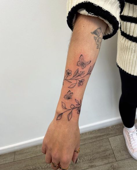 Vine Women Tattoo, Hummingbird And Ladybug Tattoo, Tattoo Ideas Female Top Of Arm, Tattoo Ideas Female Wildflower, Wrap Around Forearm Tattoo Women Butterflies, Quarter Sleeve Flower Tattoos For Women, Small Arm Wrap Tattoo, Flower Tattoos Around Arm, Butterfly And Vine Tattoo Design