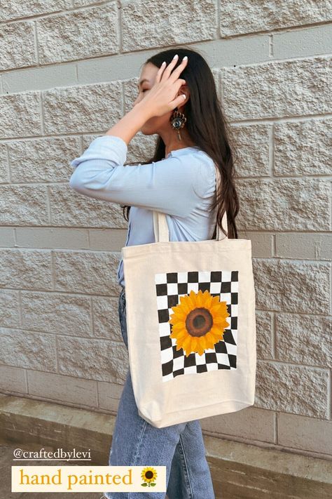 Hand-painted sunflower canvas tote bag with a nice touch of black and white checkered pattern as the background. Using a premium quality of canvas, this tote bag is sturdy -- can be use as an everyday tote bag (school/work/run errands) or to your favorite local farmer market. 🌻 Made of natural sturdy canvas (durable heavy canvas material) 👉🏼 Dimension: 15"L x 14"H x 3"W ‼️ Care Instructions: Spot clean / Air dry © CraftedbyLevi. All rights reserved. Do not copy/use/reproduce our works without permission. [Processing Time]  All items that are listed on our Etsy are ready in-stock unless noted otherwise. We typically process your order within 3-5 business days (exclude Saturday/Sunday/Holidays).  [Care Instruction] Please store the clay jewelry in a box provided by Crafted by Levi to prev Black Tote Bag Painting Ideas, Hand Painted Tote Bags, Checkered Tote Bag, Handpainted Tote, Sunflower Tote Bag, Tote Bag School, Painted Tote Bag, Handpainted Tote Bags, Farmer Market