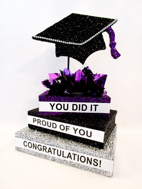 Our custom stack of books with our Styrofoam grad cap cutout makes a simple yet classic graduation table centerpiece. Sample shows the books dark pink and black with metallic tissue puffs, dark pink, black and silver. You can choose other colors, options are listed Changing the colors makes this centerpiece fun and persoanlized to fit your party color theme. Make sure to include the wording you want on the side of each book. Graduation Party Table Centerpieces, Grad Party Centerpieces, Graduation Party Inspiration, Graduation Table Centerpieces, Pink Graduation Party, Kentucky Derby Party Decorations, Graduation Table, Graduation Party Table, Graduation Book