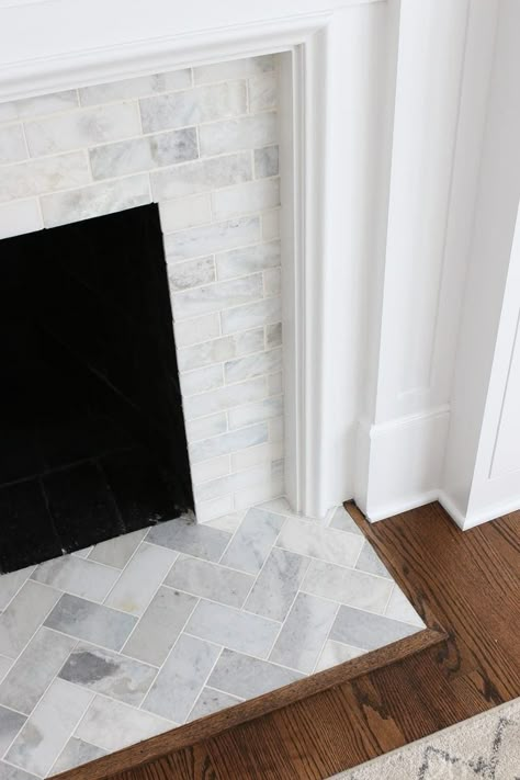 A White Marble Tile Fireplace Update | The DIY Playbook White Marble Tile Fireplace, Marble Tile Fireplace, Chevron Fireplace, Tile Hearth, Fireplace Hearth Tiles, Hearth Tiles, Diy Fireplace Makeover, Fireplace Redo, Fireplace Update