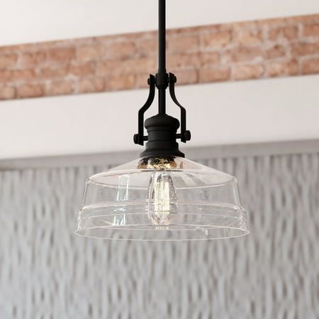 The Beloit pendant adds a welcoming and inviting feel to your kitchen or living spaces. Soft curving lines finished in matte black paired with a large clear seeded glass shade create a look that accents the most comfortable spaces. Combine that with a vintage Edison style filament bulb to complete the look. Bring a level of sophistication to your trendy farmhouse or urban style with this pendant. Size: 12-in. W x 17-in. H x 12-in. D. Over Sink Lighting Kitchen Pendants, Light Above Kitchen Sink, Over Sink Lighting, Light Over Sink, Kitchen Island Hanging Lights, Trendy Farmhouse, Modern Farmhouse Lighting, Farmhouse Kitchen Lighting, Sink Lights