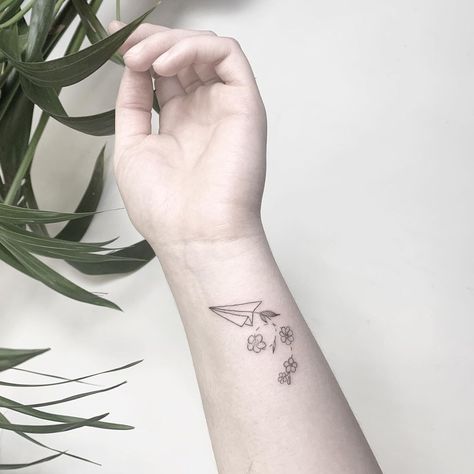 Airplane With Flowers Tattoo, Airplane Flower Tattoo, Two Paper Airplanes Flying Tattoo, Paper Aeroplane Tattoo, Aeroplane Tattoo, Small Writing Tattoos, Flower Tattoo Ear, Tattoo Airplane, Paper Airplane Tattoo