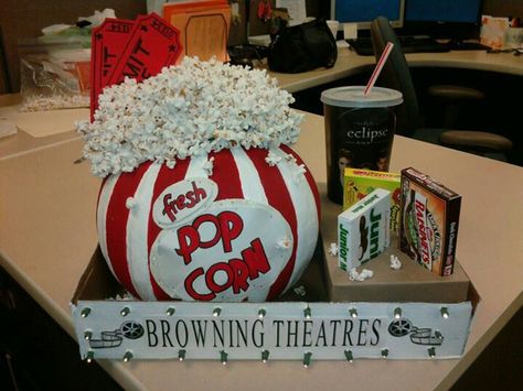 Made for work pumpkin contest. Painted pumpkin to look like old fashioned popcorn box. Strung popcorn on thread with needle. Glued round florist foam to top for heigth, then glued popcorn strands in "realistic mess". Attached 2 larger than normal "admit one" tickets with glue to foam. Used empty soda cup & empty candy boxes. Cut out holes in small box to keep candy/cup in place. Placed all in a box lid. Used battery operated lights & polked wholes thru box to mimic "marquee look". Creative Pumpkin Decorating Contest, Popcorn Pumpkin, Pumpkin Decorating Ideas, Creative Pumpkin Decorating, Autumn Spirit, Pumpkin Decorating Contest, No Carve Pumpkin Decorating, Soda Cup, Pumpkin Contest