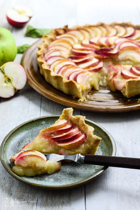 Tarte Aux Pomme or French apple tart is a classic French tart with a double helping of apple. A melt in the mouth pastry case filled with sweetened apple purée topped with sliced apples sealed in an apricot glaze. Serve cold or warm with or without cream. #onlycrumbsremain #fruittart #appletart #appleflan Pavlova Toppings, Linzer Tart, Apricot Glaze, Pastry Case, French Apple Tart, French Tart, Bramley Apple, Sliced Apples, Apple Glaze