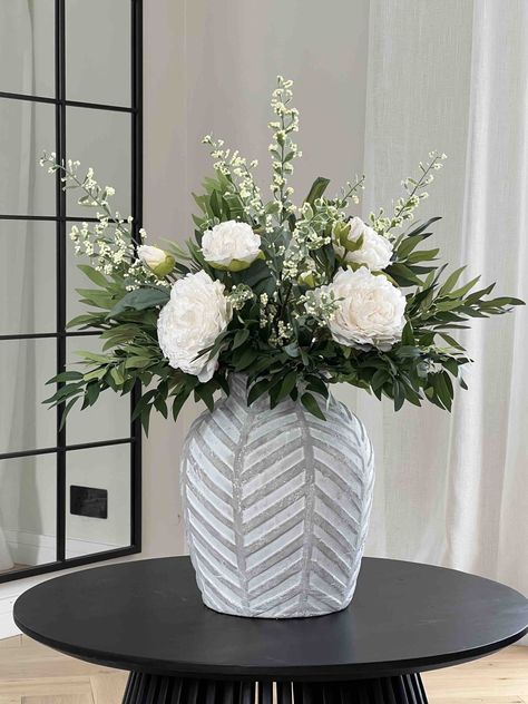 Ruscus and Peony Faux Flower Arrangement - VICTORIA Large faux flower arrangement in traditional white and green colours. This arrangements is a statement piece and will be a beautiful addition to any home or venue. Arrangement is made up from dried look peonies combined with ruscus and white berries. Approx height is approx 70-80cm Please note: vase is not included, but you can purchase it here. If this faux flower arrangement is not what you are looking for, check out our other products here. To see more photos of how our products are styled please visit our instagram page @kissmypampas Hallway Flower Arrangements, Green Vase With Flowers, Peonies Flower Arrangement, Peony Arrangements, Faux Flowers In Vase, Winter Flower Arrangements, White Berries, Green Colours, Faux Floral Arrangement