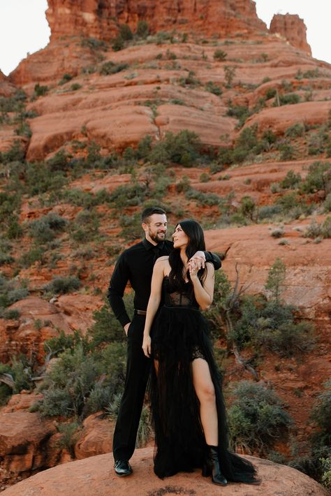 Formal-adventure-engagement-session-in-black-attire-in-Sedona,-Arizona.-Couples-photos-with-Wild-Love-&-Wanderlust.-Destination-elopement-in-black-wedding-dress.-Bell-Rock-hike.-Sultry,-moody,-goofy-couples-photography-against-the-red-rocks-in-Sedona.-Brunette-couple.-Black-on-black-formal-attire.-Adventure-wedding-photographer. Moody Engagment Shoot, Fall Engagement Outfit Ideas Dress, Edgy Engagement Photos Outfits, Dramatic Couple Photoshoot, Unique Couples Photoshoot Poses, Sedona Engagement Pictures, Sedona Engagement Photos, Dramatic Engagement Photos, Anniversary Pregnancy Announcement