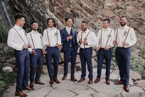 Groomsmen Navy blue suspenders champagne Navy Blue Groomsmen Suits Suspenders, Champagne Bowtie Groomsmen, Suspenders Groomsmen Attire, Off White Groomsmen Attire, Rustic Groomsmen Attire Navy, Navy Blue Tux With Suspenders, Groomsmen With Suspenders And Bowties, Groomsmen Attire Suspenders Bowtie, Navy Blue Groom And Groomsmen Suits