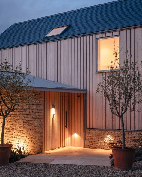 Stone and larch clad Cotswolds House by Oliver Leech Architects Cotswolds House, Cotswold Stone, Weather Stones, British Homes, Larch Cladding, British Architecture, Cottage Farm, Rural House, Arched Doors