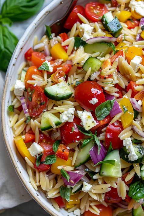 Experience the vibrant and fresh flavors of our Rainbow Orzo Salad, featuring orzo pasta tossed with cherry tomatoes, bell peppers, cucumber, and feta, all dressed in a homemade vinaigrette with a hint of lemon and honey. Homemade Vinaigrette, Lemon And Honey, Creamy Ranch Dressing, Green Beans And Potatoes, Orzo Salad, Crunchy Pecans, Orzo Pasta, Large Salad Bowl, All Recipes