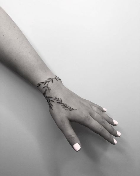 Long Wrist Tattoos For Women, Leaf Vine Hand Tattoo, Wrist Wrapping Tattoos, Black And White Hand Tattoos, Wrist Plant Tattoo, Side Thumb Tattoos Women, Fern Wrist Tattoo, Leaf Tattoo Hand, Wrist Leaf Tattoo