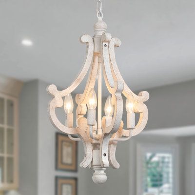 As much a work of art as a lighting fixture, this French country chic chandelier elevates the look of any room in your home, from the dining room to the entryway. This eye-catching lantern design is crafted from metal and wood and features ornate C-shaped accents that fan out around the center bulbs. It’s finished in a neutral, whitewashed hue for an antique-inspired look, and accommodates four bulbs of up to 60w bulb not included each around its candelabra base. Finish: Coat/Paint Distressing | Country Pendant Lighting, Candle Ceiling, French Country Chandelier, Country Chandelier, Cottage Dining Rooms, Chandelier Farmhouse, Lustre Vintage, Farmhouse Chandeliers, Cottage Lighting