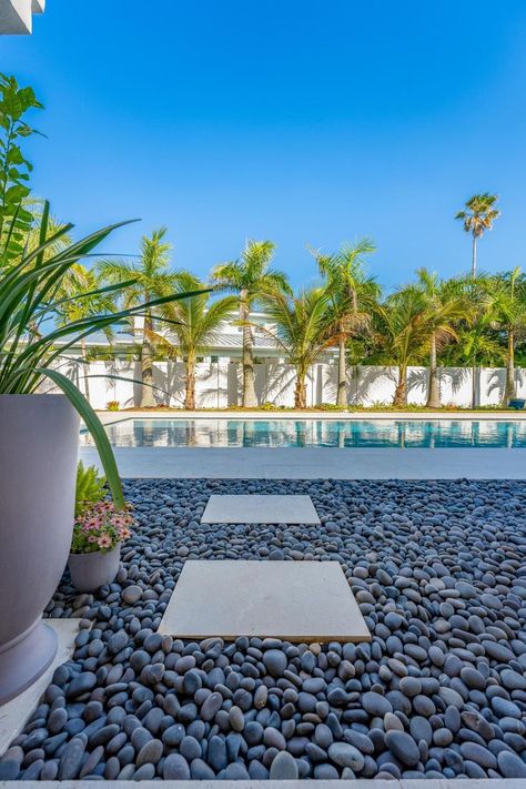 Pebbles Around Pool, No Mow Grass, Stone Pool, Melbourne Beach, Black Beach, Outdoor Gardens Design, Beach Stones, Beach Pool, Joshua Tree