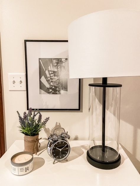 White Nightstand Decor, Nightstand With Lamp, Hang A Picture, Picture On The Wall, Small Clock, Nightstand Decor, Side Lamps, White Nightstand, Hanging Pictures