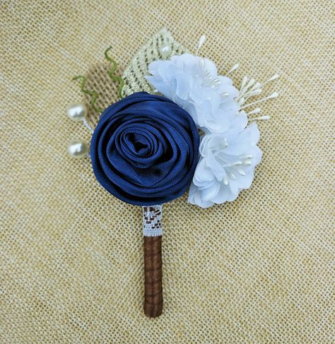 This beautiful Navy Blue Rose Boutonniere is perfect for your rustic wedding! The boutonniere is made of navy blue satin rose,white fabric flowers,burlap and fabric leaves,adorned with pearls,the stem is wrapped with brown satin ribbon,all these make the buttonhole an elegant piece. **DETAILS** 1. Size: 4 3/4 inches in length,3 inches in width. 2. Color: Navy blue,white,brown. 3. A corsage pin is included for attaching to the lapel. For the coordinating Navy Blue Bridal Bouquet here: h... Blue Rose Boutonniere, Navy Blue Bridal Bouquet, Prom Boutonniere, Boutonniere White, Blue Bridal Bouquet, Navy Groom, Navy Blue Dress Shirt, Boutonnieres Prom, White Boutonniere