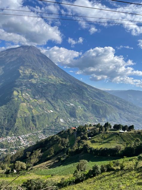 Tree covered Mountain with the town below it and a blue sky in the background Travel Latin America, Ecuador Pictures, Latin America Aesthetic, South America Culture, Ecuador Aesthetic, Columbia South America, Mind Movie, America Trip, Latin America Travel