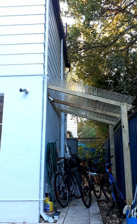 Fence Supported Bike Shelter, Diy Outdoor Bike Storage Ideas, Bike Storage Side Of House, Bike Storage Outdoor Small Spaces, Bike Storage Small Space Outside, Driveway Storage Ideas, Covered Bike Storage Outdoor, Lean To Bike Shed, Backyard Bike Storage