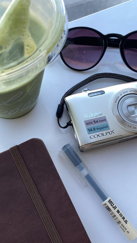 nikon coolpix digital camera muji pen journal iced matcha latte cafe aesthetic sunglasses solo date self care day cafe vibe Nikon Coolpix Camera Aesthetic, Nikon Coolpix Aesthetic, Solo Date Aesthetic, Solo Picnic, Analog Life, Aesthetic Sunglasses, Spring Gingham, Solo Date, Pen Journal