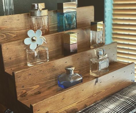 Rustic Ranch Creations on Instagram: "Our shelves make fragrance selection so much easier 🤔☺️#stepshelves #tieredshelves #fragranceshelfie #fragrancestorage #perfumecollection #perfumestorage #perfumedisplay #colognedisplay #colognecollection #fragrancecollection #farmhouseshelves #farmboho #rusticdecor #industrialdecor #rusticranchcreations" Diy Perfume Display, Wall Mounted Makeup Organizer, Fragrance Display, 2023 Vibes, Weathered Oak Stain, Step Shelves, Red Oak Stain, Torch Wood, Bottle Shelf