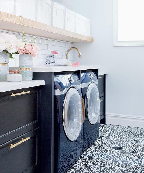 The Curated House - White and black laundry room features a long, floating shelf lined with white canvas bins suspended over an enclosed washer and dryer. Transitional Laundry Room, Laundry Room/mud Room, Stylish Laundry Room, Basement Laundry Room, Dream Laundry Room, Basement Laundry, Laundry Room Inspiration, Laundry Mud Room, Laundry Room Makeover