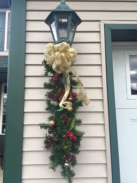 I made this Christmas swag and my own bows.. I make them to hang under our lights outside.. Christmas Lamp Post, Lights Outside, Porch Lights, Christmas Lamp, Christmas Swag, Light Pole, How To Hang, Christmas Swags, Office Christmas