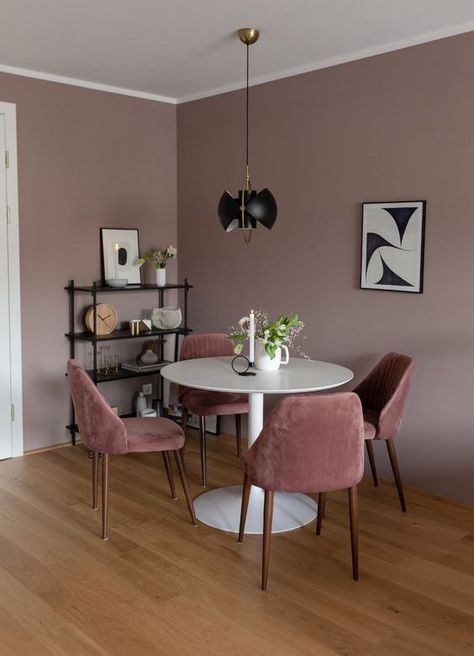 a mauve dining room with a white round table, pink chairs, a black shelving unit and a black pendant lamp Mauve Living Room, Interior Wall Colors, Room Color Combination, Living Room Wall Color, Room Wall Colors, Bedroom Wall Colors, Home Design Living Room, Paint Colors For Living Room, Living Room Colors