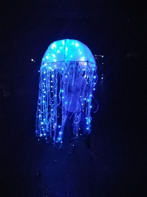 Jellyfish Halloween costume. Clear umbrella, bubble wrap, blue & white Christmas lights,  clear/rainbow door streamers, low temp hot glue. Jellyfish Costume With Clear Umbrella, Light Up Jellyfish Costume, Umbrella Jellyfish Costume, Jellyfish Umbrella Costume, Jellyfish Umbrella Diy, Jellyfish Costume Umbrella, Door Streamers, Jellyfish Costume Diy, Jellyfish Umbrella