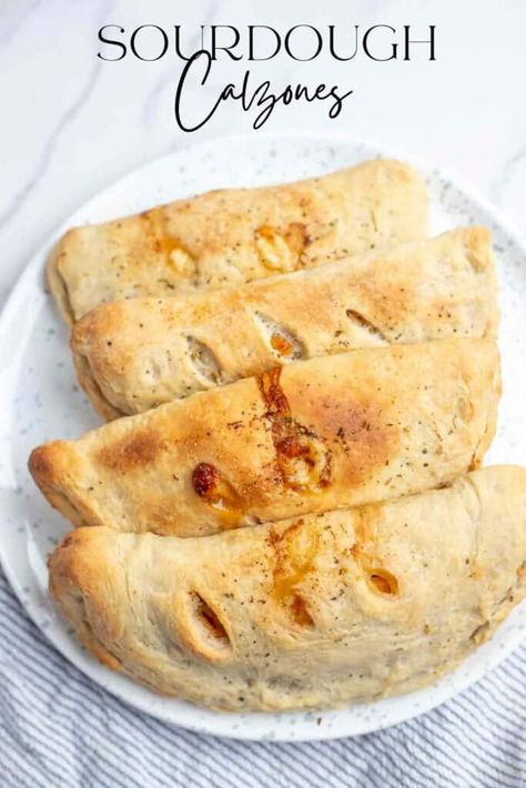 Take pizza night up a notch with these sourdough calzones. Made with a flavorful sourdough crust, fill each calzone with sauce, cheese, and your favorite pizza toppings, like red onion, green peppers, or sausage - the options are endless! #FarmhouseonBoone #SourdoughCalzone Sourdough Calzone, Calzone Dough, Sourdough Crust, Farmhouse On Boone, Spicy Pizza, Recipe Using Sourdough Starter, Sourdough Pizza Crust, Calzone Recipe, Sourdough Starter Discard Recipe