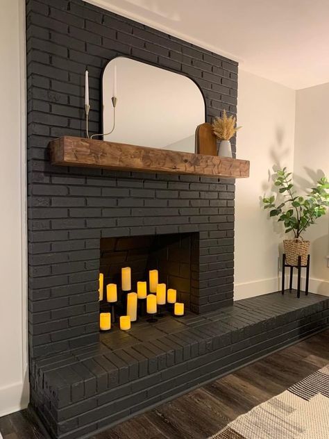 Living Room With Black Brick Fireplace, Black Fireplace Black Beams, Basement Brick Fireplace Makeover, Half Wall Brick Fireplace, Painted Brick Hearth, Black Brick Fireplace Green Walls, Charcoal Painted Fireplace, Sealed Fireplace Ideas, Peppercorn Fireplace Brick