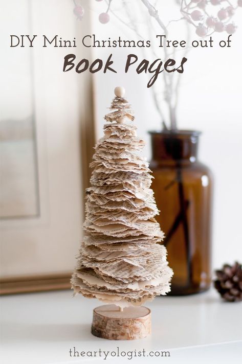 A little Christmas tree decoration made out of old book pages, sitting on a shelf with a vase of branches in the background Christmas Tree Out Of Books, Making A Tree, Paper Garlands, Book Christmas Tree, Old Book Crafts, Christmas Tree Crafts, 12 December, Holiday Crafts Christmas, Mini Christmas Tree