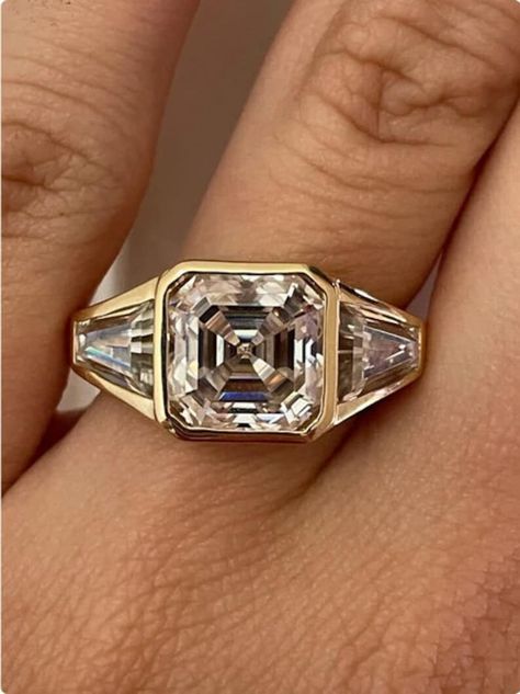 "2 CT Asscher Cut Moissanite Engagement Ring, Three Stone Wedding Ring, Full Bezel Set Gold Anniversary Gift Ring, Promise Ring Proposal Ring, Asscher Cut Moissanite Wedding Ring, Three Stone Moissanite Engagement Ring, 18k Gold Bezel Set Moissanite Ring, Women Anniversary Gift, Three Stone Moissanite Engagement Ring, Asscher Cut Side Stone Tapered Baguette Ring, Bezel Setting Engagement Ring, 3 Stone Diamond Ring, Moissanite Ring Set, Velvet Jewelry Box. \"The stones in the jewelry are 100% handmade, they are cut and polished by our experienced craftsman.\" ✱ 𝐃𝐞𝐬𝐜𝐫𝐢𝐩𝐭𝐢𝐨𝐧 𝐎𝐟 𝐑𝐢𝐧𝐠 Metal Type : 925 Silver / 10K Gold / 14K Gold / 18K Gold Metal Tone : White / Yellow / Rose Gold Stamp/Hallmark: Yes ✱ 𝐂𝐞𝐧𝐭𝐞𝐫 𝐒𝐭𝐨𝐧𝐞 𝐈𝐧𝐟𝐨𝐫𝐦𝐚𝐭𝐢𝐨𝐧 ↣Type: Moissanite ↣Shape: Assc Tennis Ring Diamond, Three Stone Wedding Ring, Bezel Set Wedding Ring, Engagement Ring Three Stone, Asscher Cut Ring, Stone Wedding Ring, 3 Stone Diamond Ring, Bezel Set Engagement Ring, Moissanite Ring Set