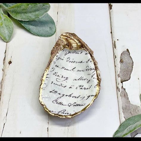 With A Gold Leaf Paint Trim, This Upcycled Decoupage Oyster Trinket Dish Makes A Perfect Catchall For Your Jewelry And Doubles As A Decor Piece For Your Home. Each Trinket Dish Is Handcrafted With Care And Is An Eco-Friendly Alternative To The Traditional Jewelry Box. -100% Authentic Oyster Shell -Natural White Back -French Script Decoupage Design -Each Purchase Plants A Tree -Comes With Biodegradable Jute Bag -Made By Artisans In Massachusetts, Usa -Shell Sourced From Oyster Bar In Florida, Usa Oyster Jewelry, Gold Leaf Paint, Jewelry Roll Travel, Necklace Jewelry Display, Ballerina Jewelry, French Script, Elephant Earrings, Jewelry Roll, Usa Jewelry