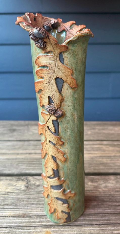 Gambrel Oak Vase from Majorie King Studio- One of a kind handmade nature theme pottery. Wheel thrown, then decorated using additions built by hand from kiln fired clay, which is made from leaves that are sculpted into clay.  Using a 14 step propriety process that takes approx. 15,000 hand stokes to complete the leaves. Marjorie is the only clay artist that has successfully mastered this technique. Each piece is unique.  All pieces are individually signed. Wheel Thrown And Hand Built Pottery, Garden Clay Ideas, Advanced Pottery Projects, Slab Built Pottery Ideas, Wheel Thrown Vases, Pottery Vases Ideas Clay, Functional Ceramics Ideas, Pottery Challenge, Clay Handbuilding Ideas