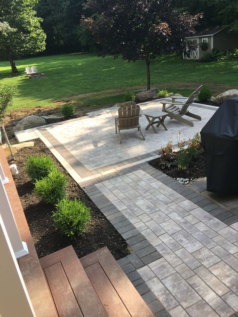 L Shaped Concrete Patio, Patio Paver Edging Ideas, Paver Patio Sloped Yard, Grey Pavers Patio Backyards, Step Down Patio Backyards, Modern Paver Patio Ideas, Paver Deck Ideas, Deck And Paver Patio Combo, Pavers Around Concrete Patio