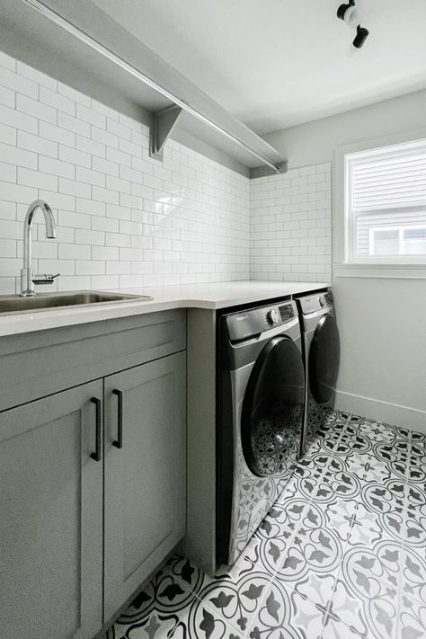 We love a bold floor tile in the laundry room. Such a beautiful custom element for our client! Subway Tile Laundry Room Wall, Laundry Room With Fun Tile, Mosaic Tile Laundry Room Floor, Laundry Black And White Floor, Pattern Laundry Room Tile, Laundry Room Design Tile Floor, Spanish Tile Laundry Room, Farmhouse Laundry Room Flooring, Small Laundry Room Tile Floor