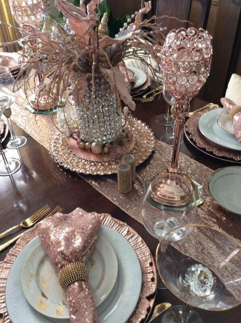 Decorate your dining table with rose gold décor accents for a contemporary & glamorous look. Spread a rose gold sequin runner in the center of your dining table and set a rose gold charger plate in the center to place a crystal-beaded vase on top. Arrange goblet candle holders atop hexagonal mirrors for a charming appeal and elevate your place settings by folding rose gold sequin napkins into gold rings and place them atop marble plates & rose gold reef chargers.