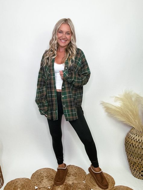 Green Plaid Flannel Oversized Shirt with Side Step Hem Elevate your fall wardrobe with our Green Plaid Flannel Oversized Shirt. Made from a cozy blend of 65% polyester and 35% cotton, this shirt features a classic button-up front and a single chest pocket. The oversized fit and side step hem offer a relaxed and flattering silhouette, making it perfect for layering over a basic tank or graphic tee. Ideal for casual outings, cozy get-togethers, or a day of running errands, this versatile plaid fla Flannel Cute Outfits, Oversized Green Flannel Outfit, Cute Fall Outfits With Flannels, Flanel Outfit Woman, Oversized Flannel Outfits Grunge, Outfits With Plaid Shirts, Flannel And Leggings Outfit, Oversized Plaid Shirt Outfit, Flannel Shirt Outfits