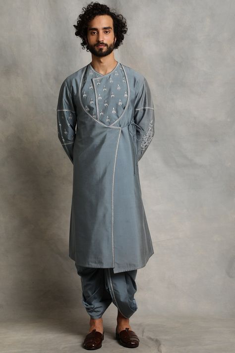 Featuring a canyon blue angrakha kurta in cotton silk base with embroidery. It is paired with matching dhoti pants.  FIT: True to size. COMPOSITION: Cotton silk. CARE: Dry clean only. Angarkha Kurti Pattern, Angarkha Kurti, Angrakha Style Kurti, Kurta Designs Men's, Indian Wedding Suits Men, Blue Sherwani, Angrakha Kurta, Garba Dress, Wedding Kurta For Men