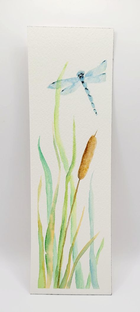 This original watercolor bookmark features a blue dragonfly flying through the grass above a cattail. The background is white. The back is blank except for initials and date in the bottom corner. Rough Dimension: 7.75" x 2.5" Don't hesitate to contact me with any questions or requests!  These one-of-a-kind bookmarks are like little pieces of art for your favorite books! Crafted with care and creativity, they make perfect gifts for book lovers or charming placeholders for your reading collection. Watercolor Art Bookmarks, Simple Bookmark Ideas, Easy Watercolor Bookmarks, Watercolor Bookmarks Ideas, Dragonfly Watercolor Painting, Dragonfly Flying, Bookmark Watercolor, Handmade Bookmarks Diy, Watercolor Dragonfly