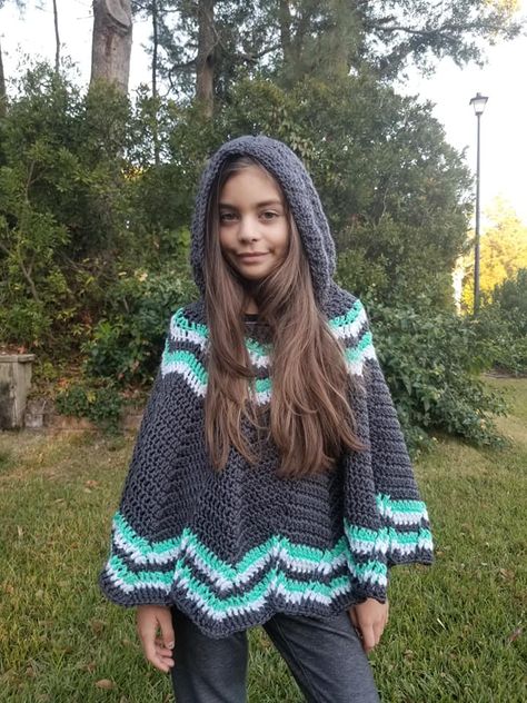 Free Crochet Poncho Pattern- child sizes- Big MountainNOVEMBER 28, 2019 BY: LORENEThe Big Mountain Poncho is a free crochet poncho pattern in children’s sizes 2-12yo. It is a form-flattering design that is made from the top down in a chevron design. The beginning rows are increased in an unusual method that provides continuity of the stitch pattern with a bottom edging that features an interesting textural component. The Big Mountain Poncho features an optional hood and is also available as a Hooded Poncho Knitting Patterns, Chunky Poncho Crochet Pattern, Chunky Yarn Crochet Pattern Free, Poncho Knitting Patterns Free, Nanny Fran, Penguin Pillow, Crochet Poncho Kids, Crochet Poncho Pattern, Crochet Children