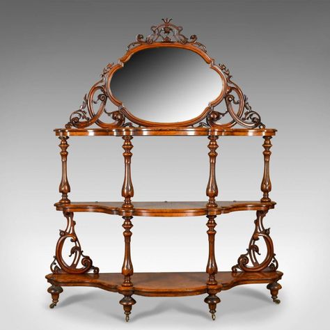 This is an antique whatnot, an Irish, burr walnut, three tier, mirror-back, display Stand by the highly regarded Robert Strahan & Co. firm of Dublin, Ireland. Dating to the early to mid-19th century, circa 1840.  Of exceptional quality befitting of such a renowned cabinet maker The well figured, burr walnut displays beautifully in the lustrous wax polished finish  The three serpentine tiers feature chamfered profiles Raised on inverted bell flower pillars, turned and carved To the lower rear, ex Mirror Stand, Walnut Mirror, Vintage Shelving, Antique Wax, Mirror Plates, Storage Cabinet Shelves, Trellis Design, Walnut Table, Standing Mirror