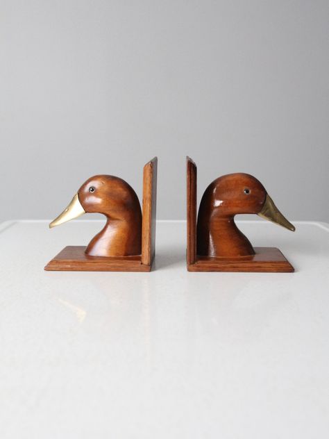 "This is a pair of vintage duck bookends. Wood and brass shape the classic bookend pair. CONDITION In good condition with wear consistent with age and use. Some scratches to the wood (primarily on the base). MEASUREMENTS Height: 5.25\" .. 13.3 cm Width: 4.25\" .. 10.8 cm Depth: 5.5\" .. 14 cm 121978" Vintage Plane Nursery, Bookends Wood, Duck Bookends, Little Accessories, Cabin Renovation, Wooden Duck, Vintage Duck, Dream Nurseries, Copper Wall