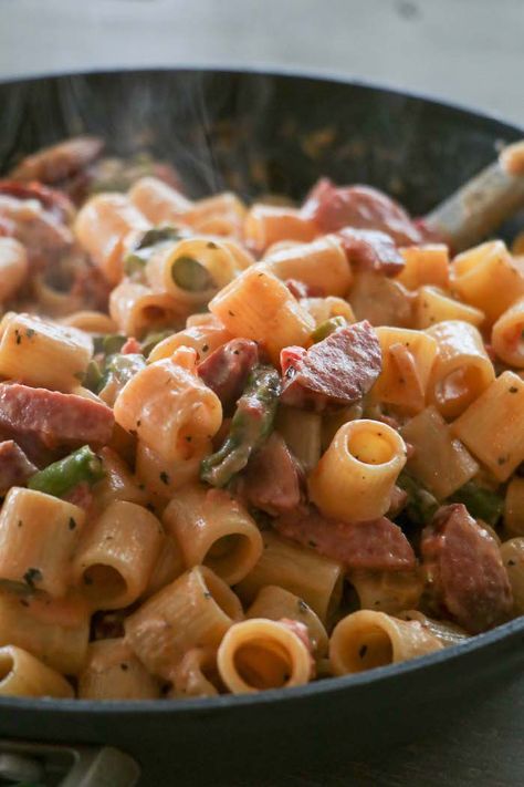 This easy 30 minute meal is a family favorite dinner that will have you licking your plates clean! This supper is full of flavor with very few ingredients. Smoked sausages, asparagus, garlic onions and pasta tossed together in a creamy tomato sauce. It's as easy as that! Sausage Asparagus Pasta, Smoked Sausage Recipes Pasta, Sausage Pasta Recipe, Smoked Sausage Pasta, Balanced Recipes, Sausage Pasta Recipes, 30 Minute Meals Easy, Ditalini Pasta, Asparagus Pasta