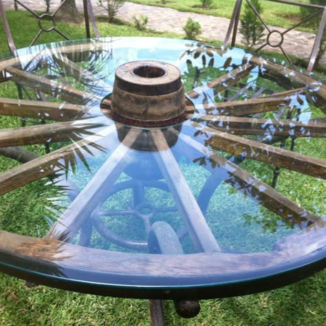 WagonWheel Table                                                                                                                                                                                 More Rustic Wagon Wheel Decor, Wheel Table Ideas, Old Wheel Ideas, Wagon Wheel Coffee Table, Carasoul Table, Wagon Wheel Decor Outdoor, Table Made From Car Wheel, Wagon Wheel Table, Wire Wheel Table Diy Cable Reel