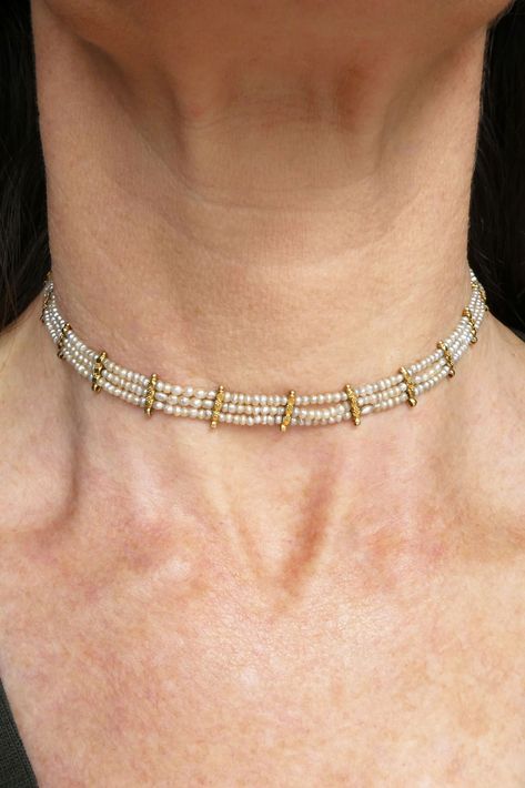 From the Edwardian era, this wonderful pearl and 16ct gold choker necklace consists of countless natural seed pearls hand strung in a three-strand design with eighteen flower embellished dividers, secured by a square box clasp. As well as ornamention, the gold dividers have a lower loop function where gemstone drops likely suspended from at one stage. Today, you may like to leave as is, add your favourite antique lavalier pendant, or bedeck it as it would've been in the Edwardian era! 🤍 The Edwardian Era, Contemporary Clothes, Black Beaded Jewelry, Pearl Jewellery, Gold Choker Necklace, Box Clasp, Gold Choker, Edwardian Era, Seed Pearl