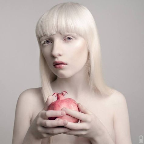 Nastya Zhidkova holding a pomegranate Pomegranate Reference, Holding Pomegranate, Nastya Zhidkova, Albino Model, Greek Goddess, White Aesthetic, White Hair, Color Photography, Fine Art Photography